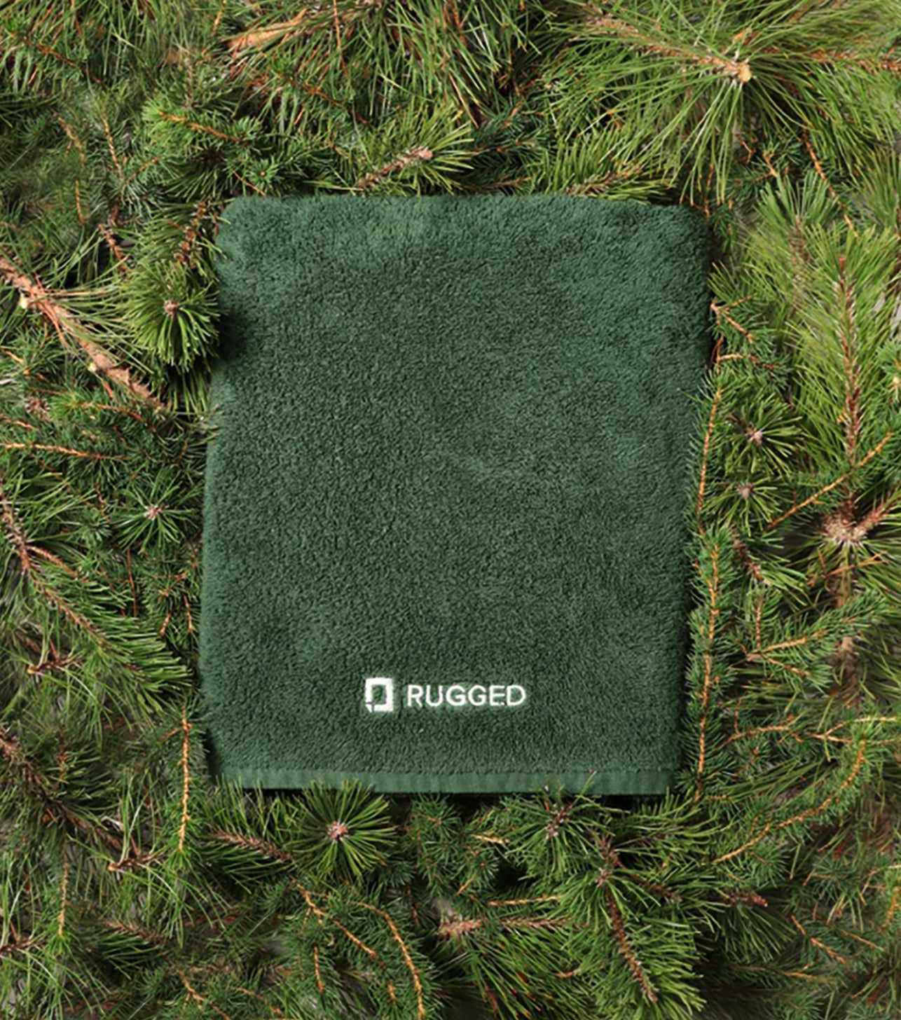 The Pine Towel-big bath towel-Turkish towel-towel resting on a bed of pine tree branches and needles