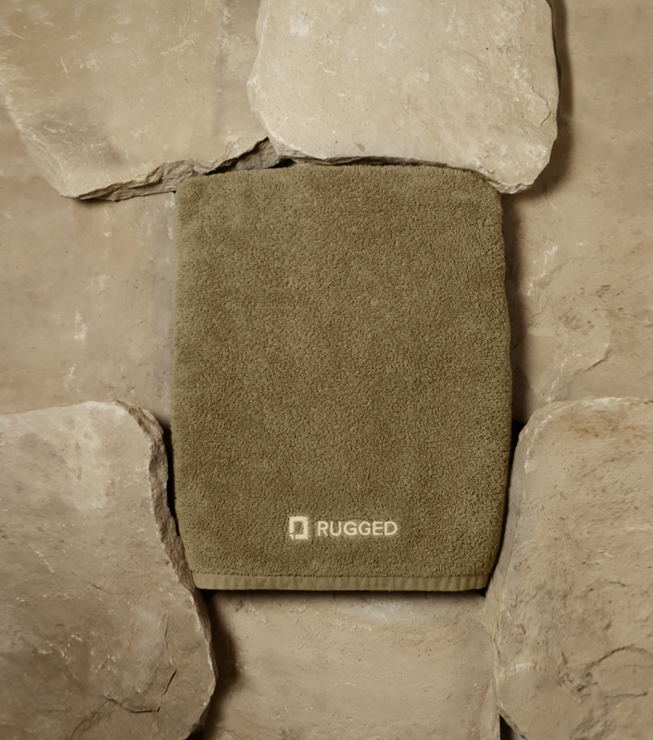 The Sandstone Towel-big bath towel-Turkish towel-towel resting on a bed of sandstone rocks