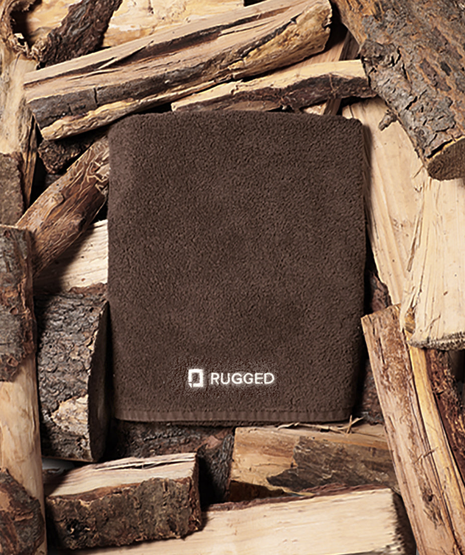 The Timber Towel-big bath towel-Turkish towel-towel resting on a bed of fresh cut wood/timber.